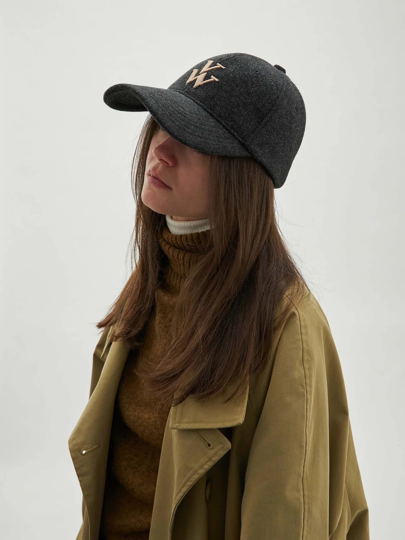 - Casquette noir et gris anthracite en feutre
- Visière avec surpiqûres décoratives
- Monogramme brodé beige
- Couronne en 6 pans avec œillets brodés
- 2 pans avant rigides
- Bande de propreté intérieure
- Fermeture arrière réglable à scratch